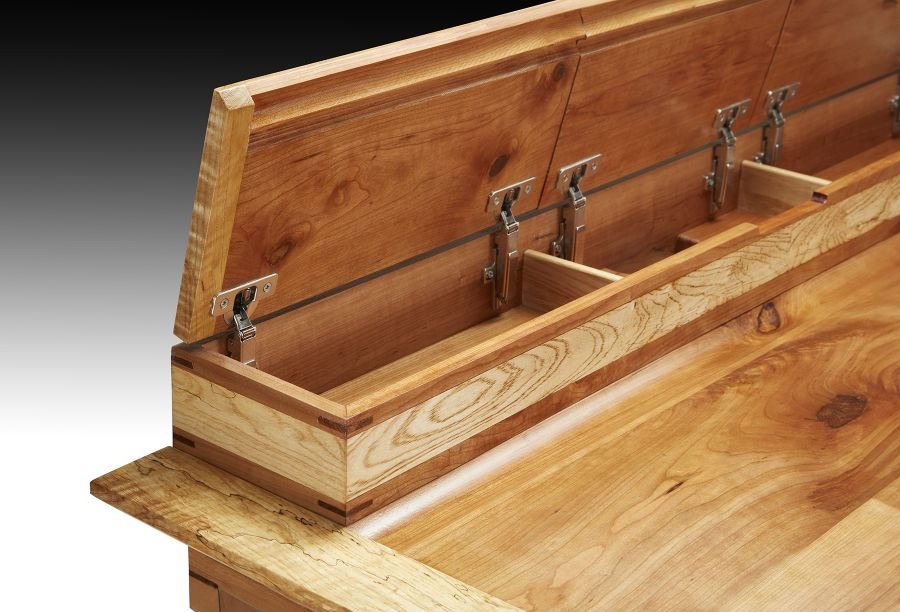 Writing desk with the hinged top lid open, showing divided storage