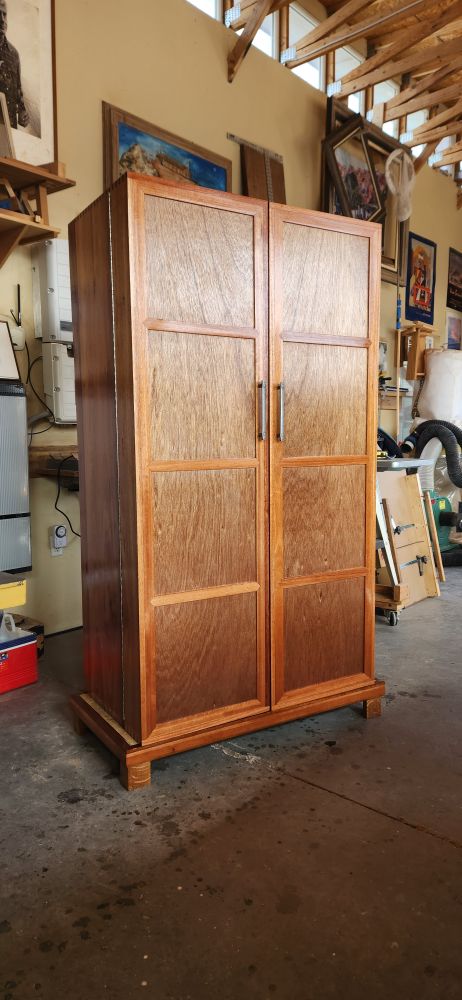 Finished Red Grandis liquor cabinet in the dadowoodworking workshop in Chamberino, New Mexico