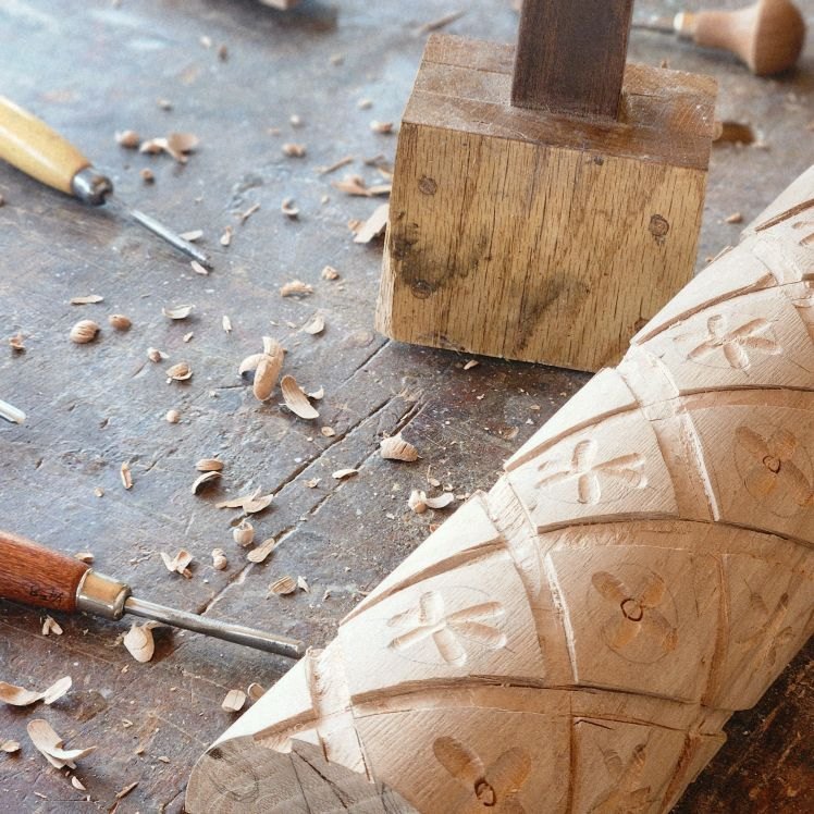 Hand-carving the coffee table legs at the workbench