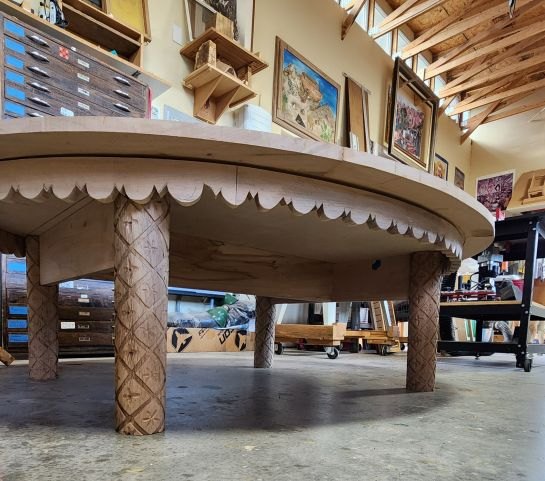 Coffee table in the workshop, showing the scalloped apron and hand-carved legs
